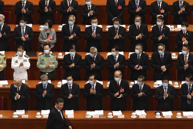 Delegates applaud as Chinese President Xi Jinping arrives for the opening session of China’s National People’s Congress (NPC) at the Great Hall of the People in Beijing, Friday, May 22, 2020. (AP Photo/Ng Han Guan, Pool)